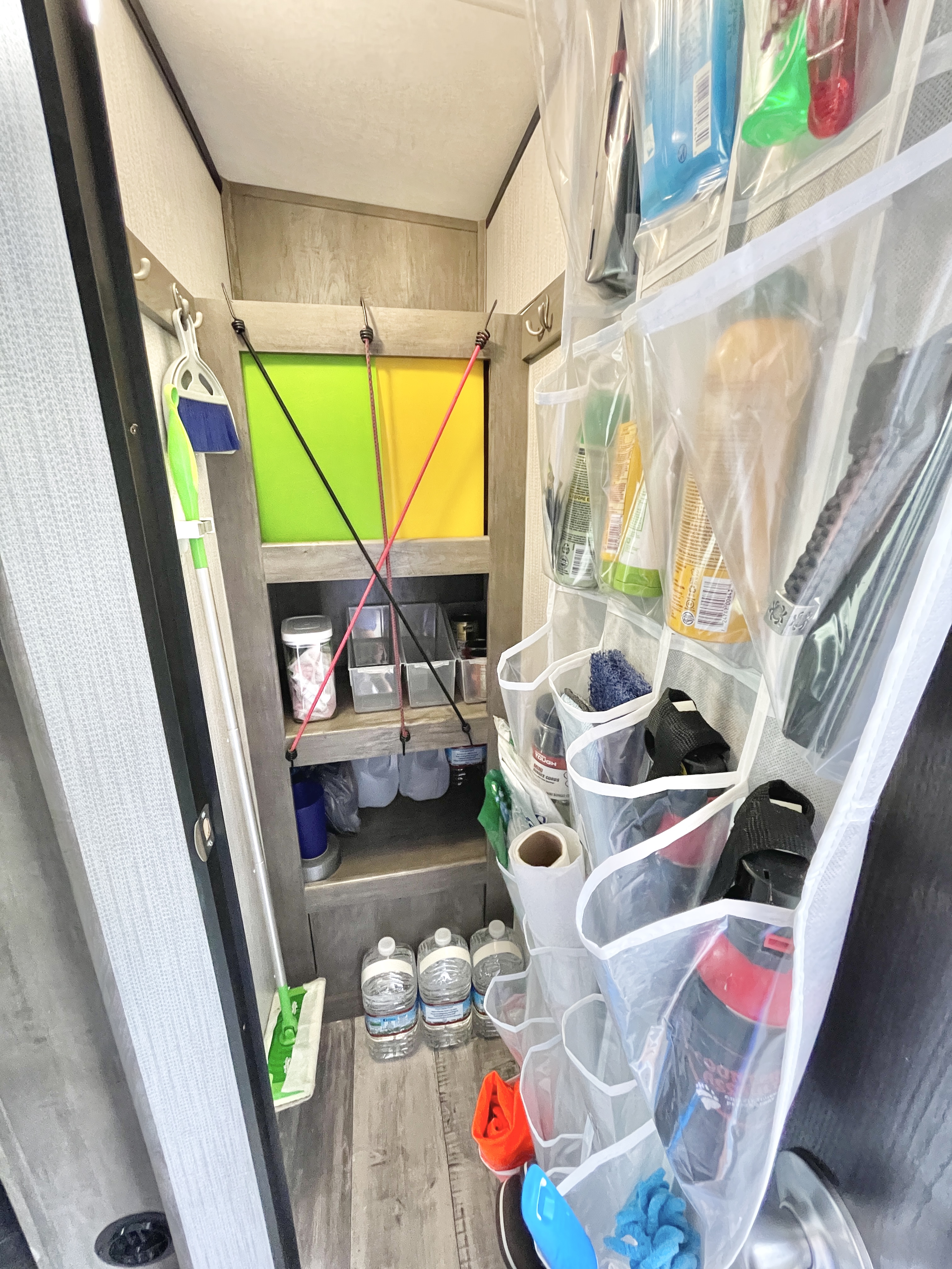 Stephanie Y. Deininger's closet inside her RV organized using cubbies and bunjie cords