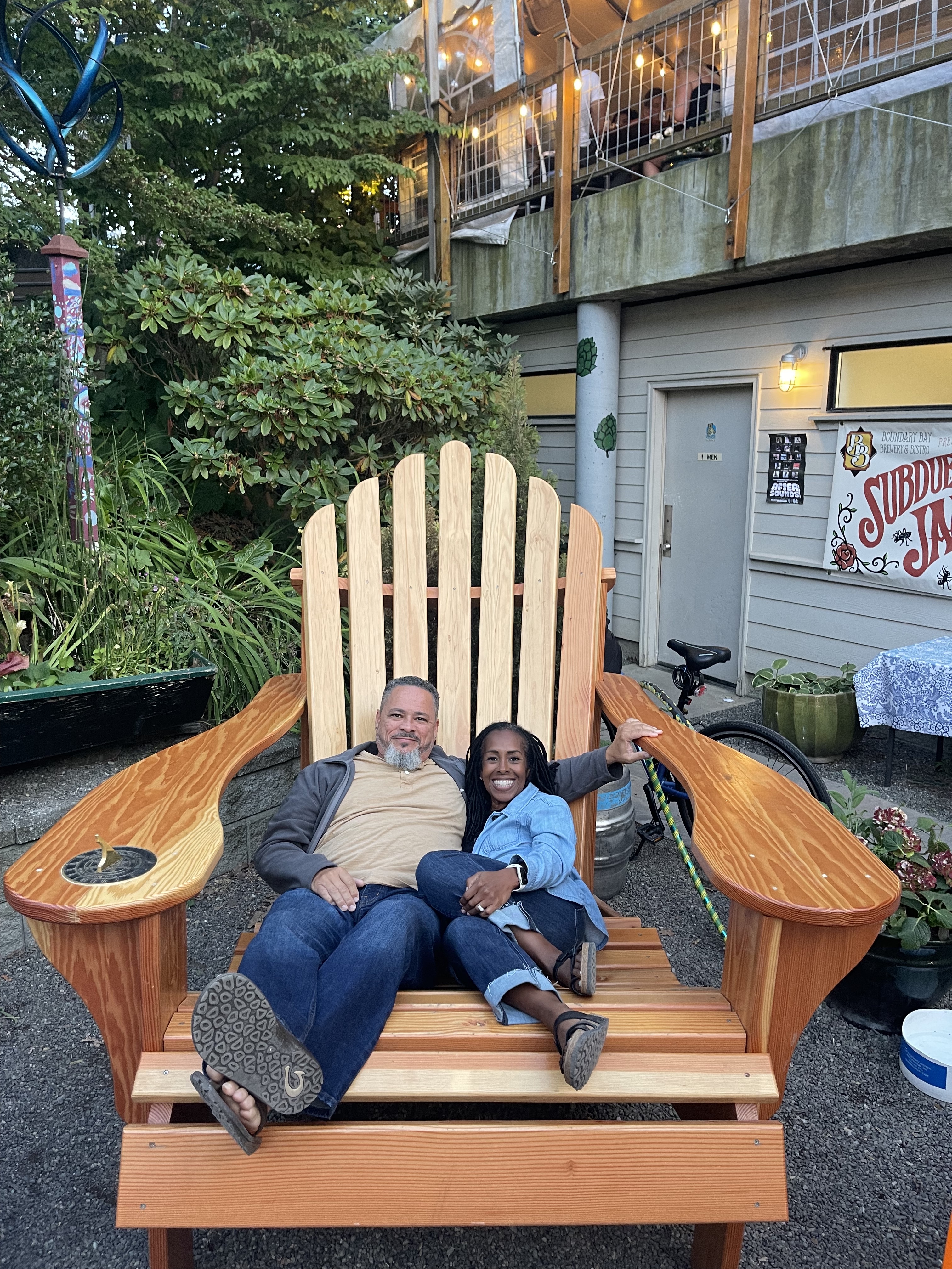 Robin and Warren Baxter sitting in a large adirondack chair