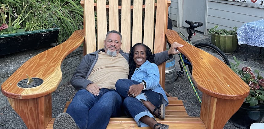 Robin and Warren Baxter sitting in a large adirondack chair