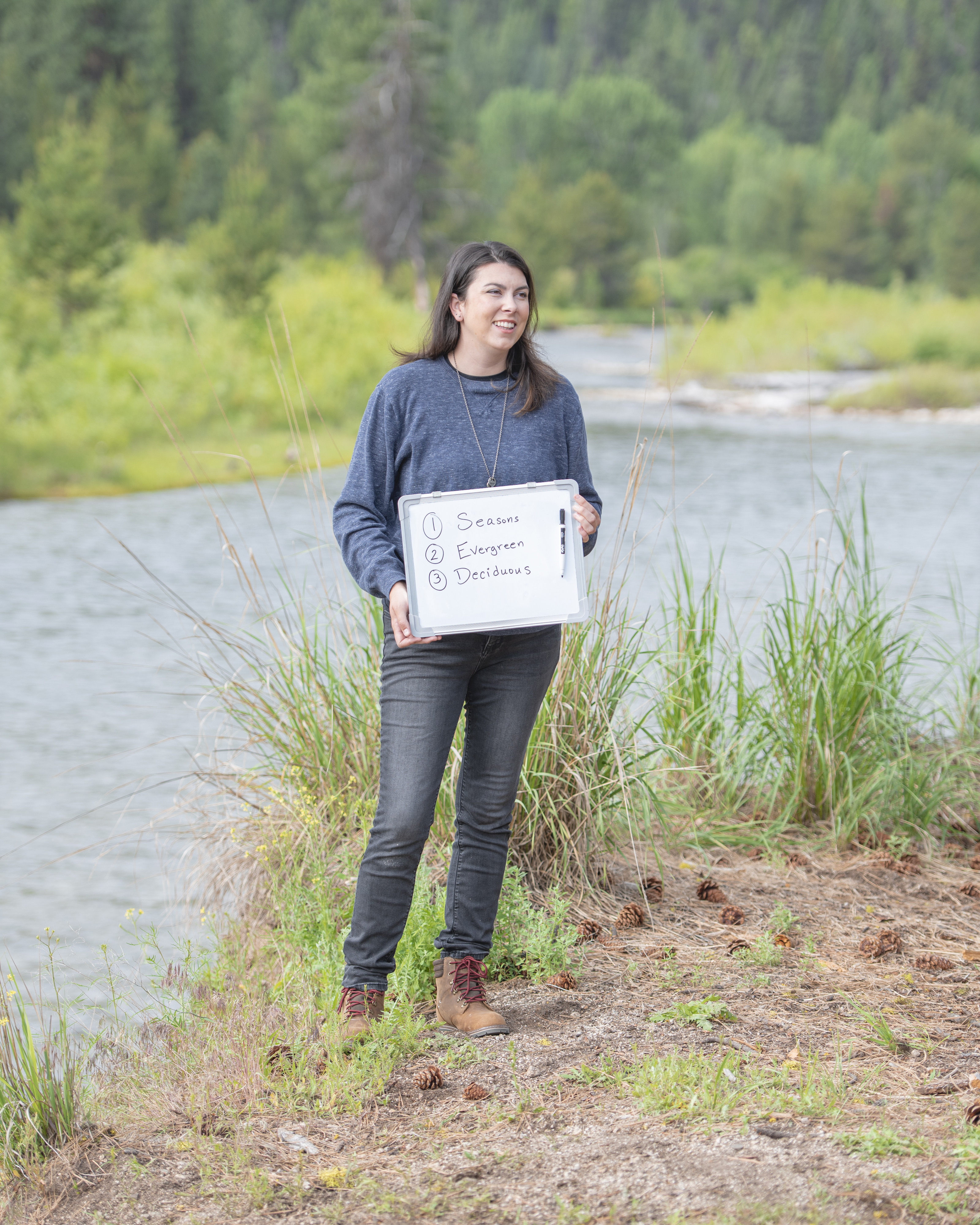 Chelsea Day holds up a dry erase board for a lesson