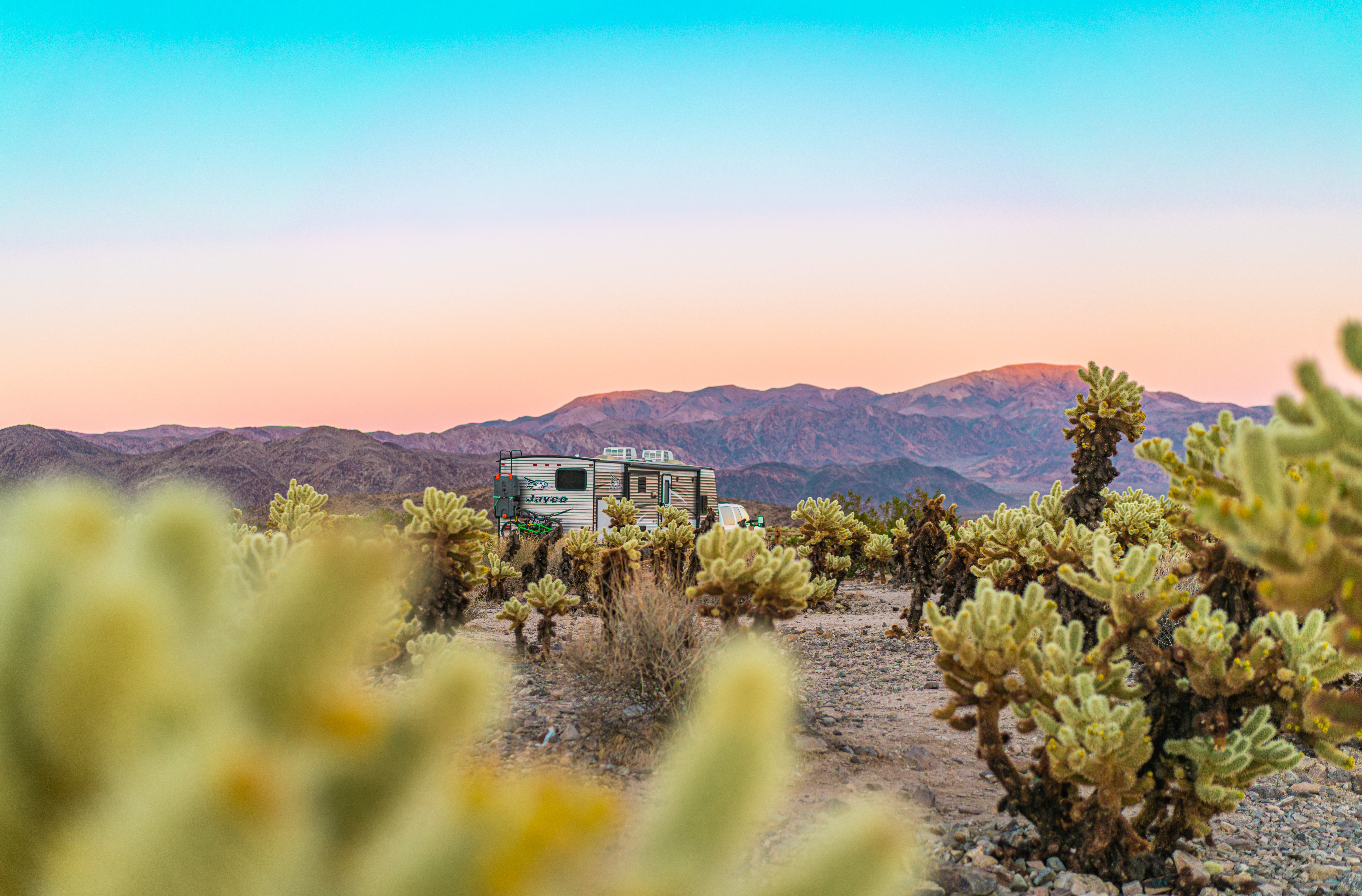 Renee Tilby's RV parked by mountain dessert at sunset