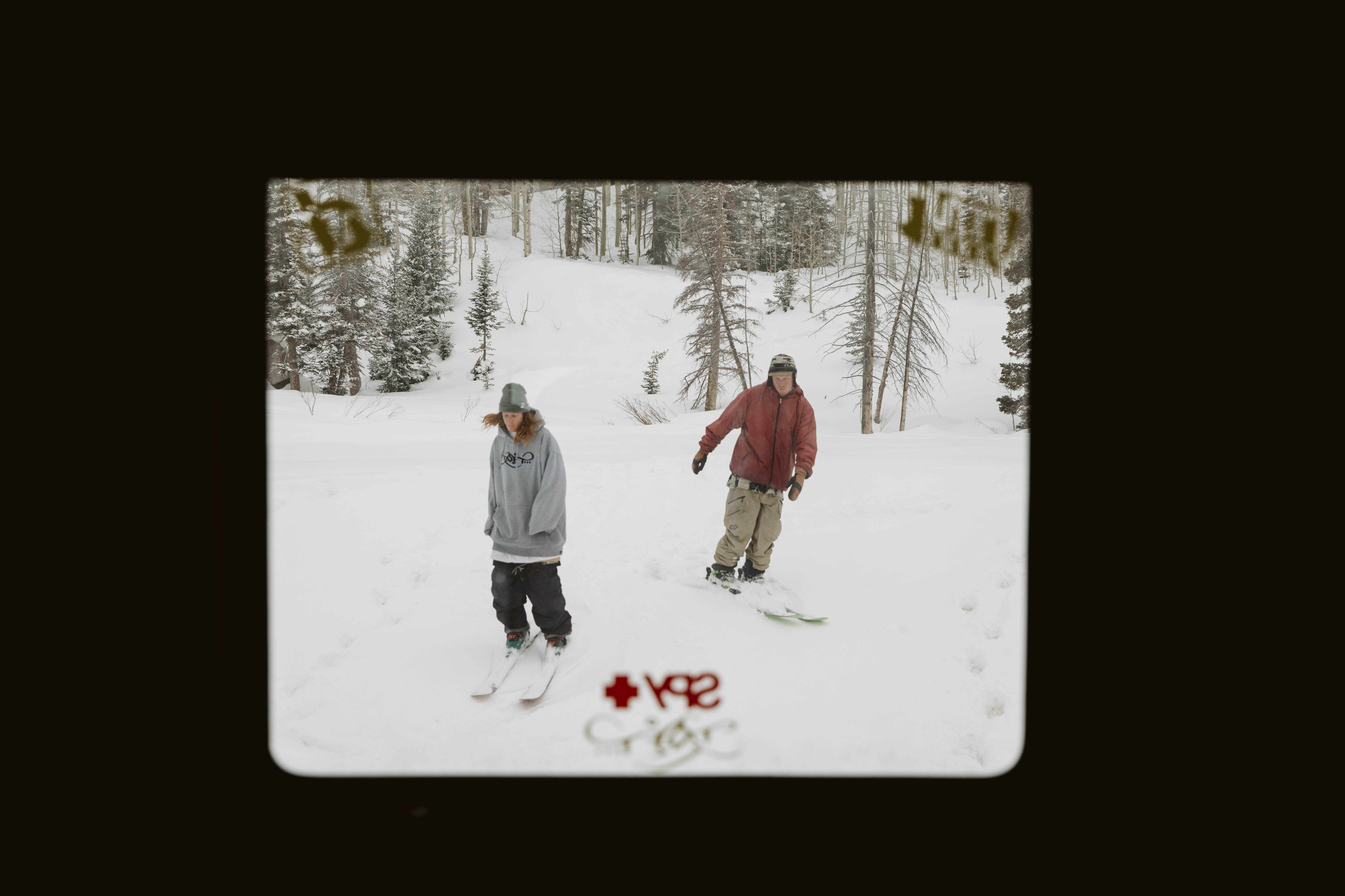 Ryan Barrick and a friend skiing outside an RV window.