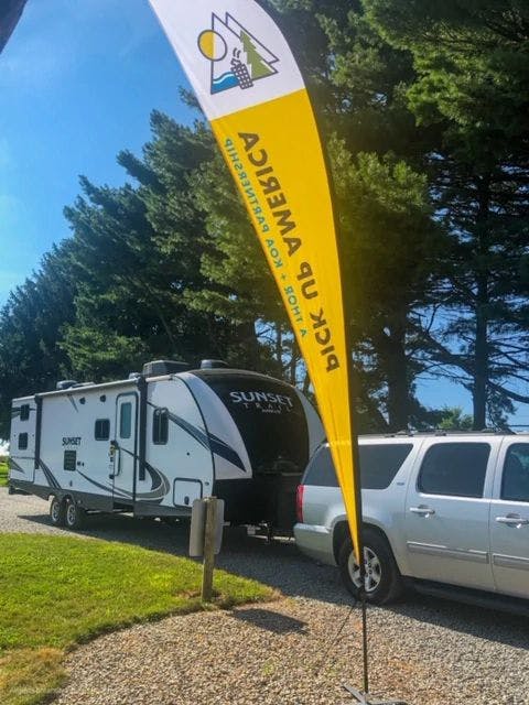 The Gleason's RV parked near a Pick Up America flag