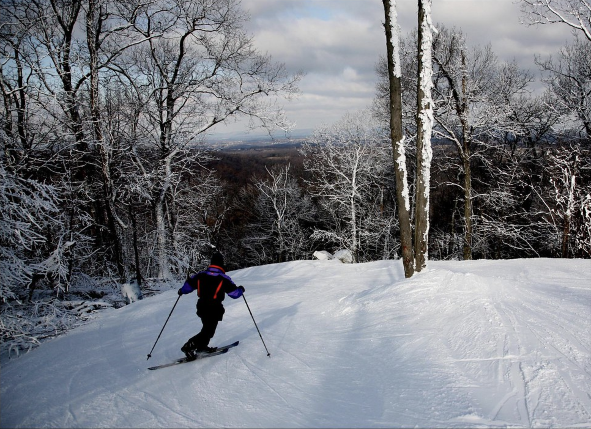 Skier at the top of a hill at Roundtop Mountain in Lewsiberry, PA
