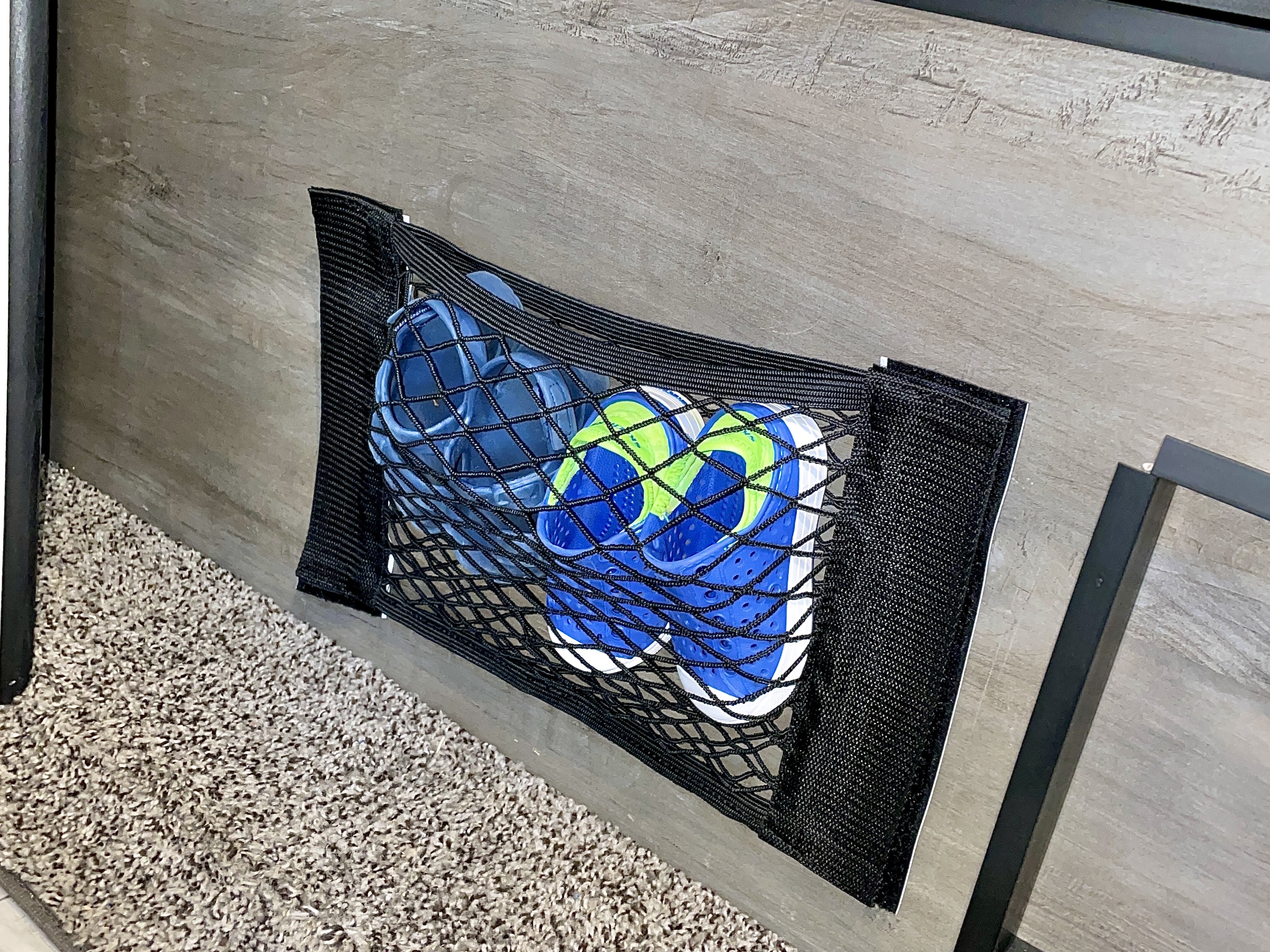 Stephanie Deininger putting her kids' shoes in netting storage 