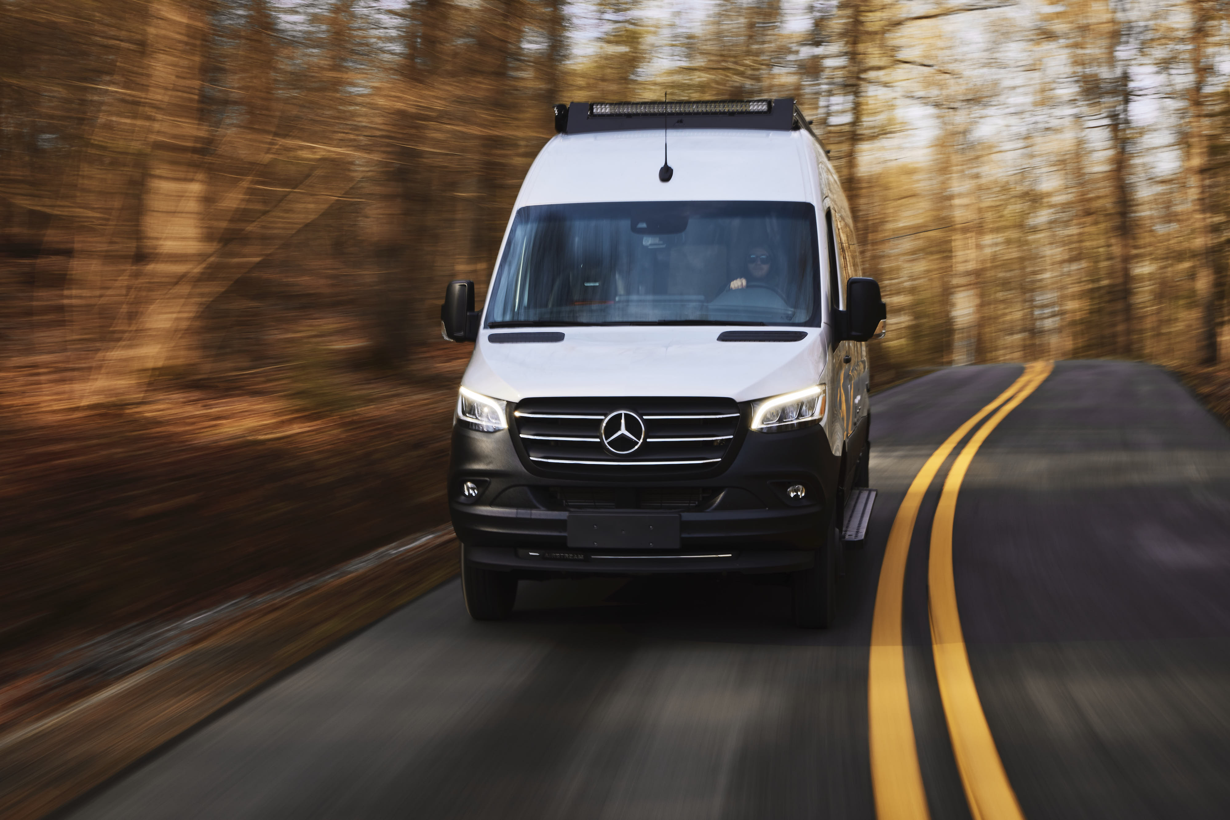 Kathy Karlo driving an Airstream camper van