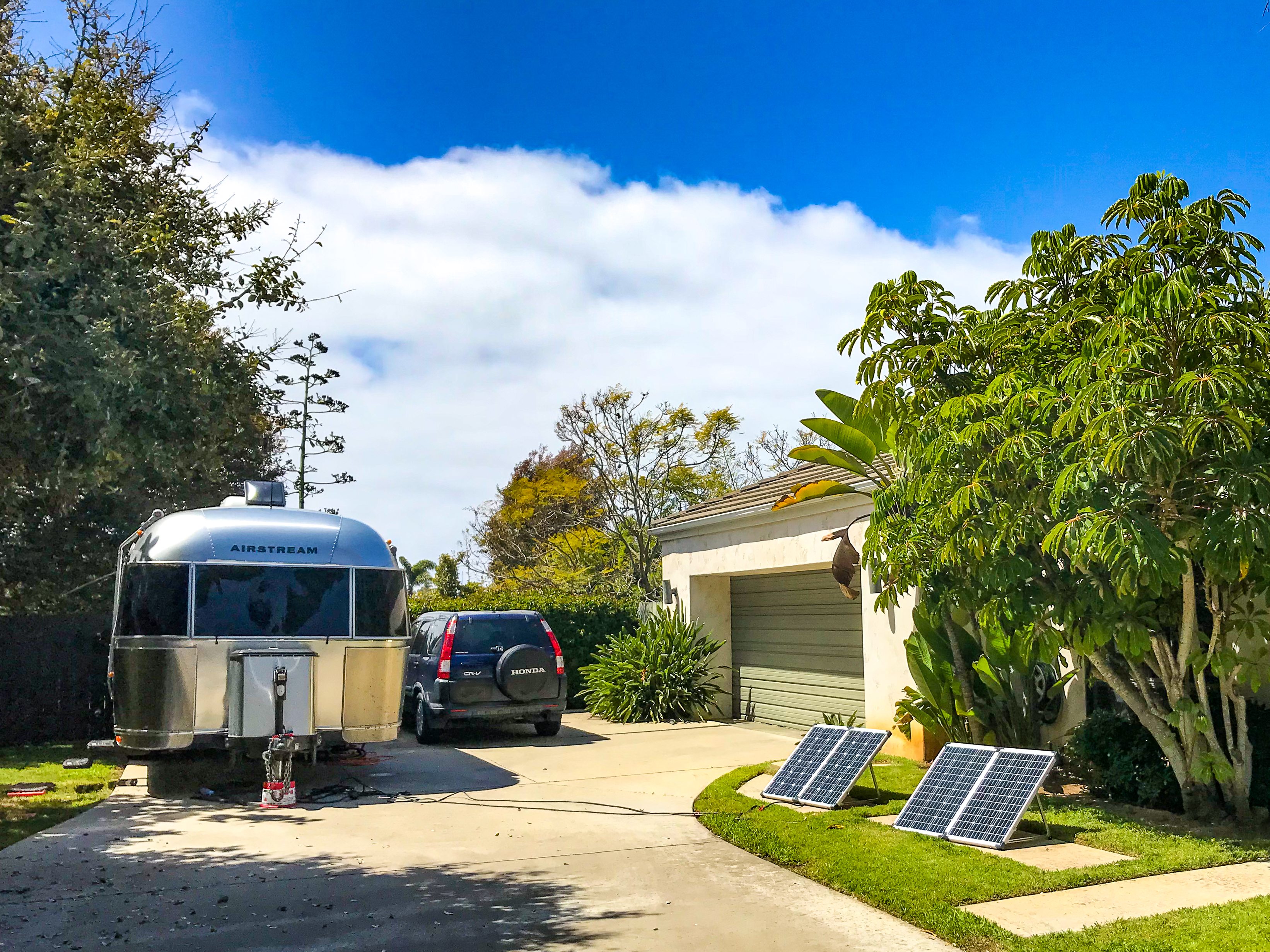 Greg Graham's Airstream parked in a driveway with solar panels set up.