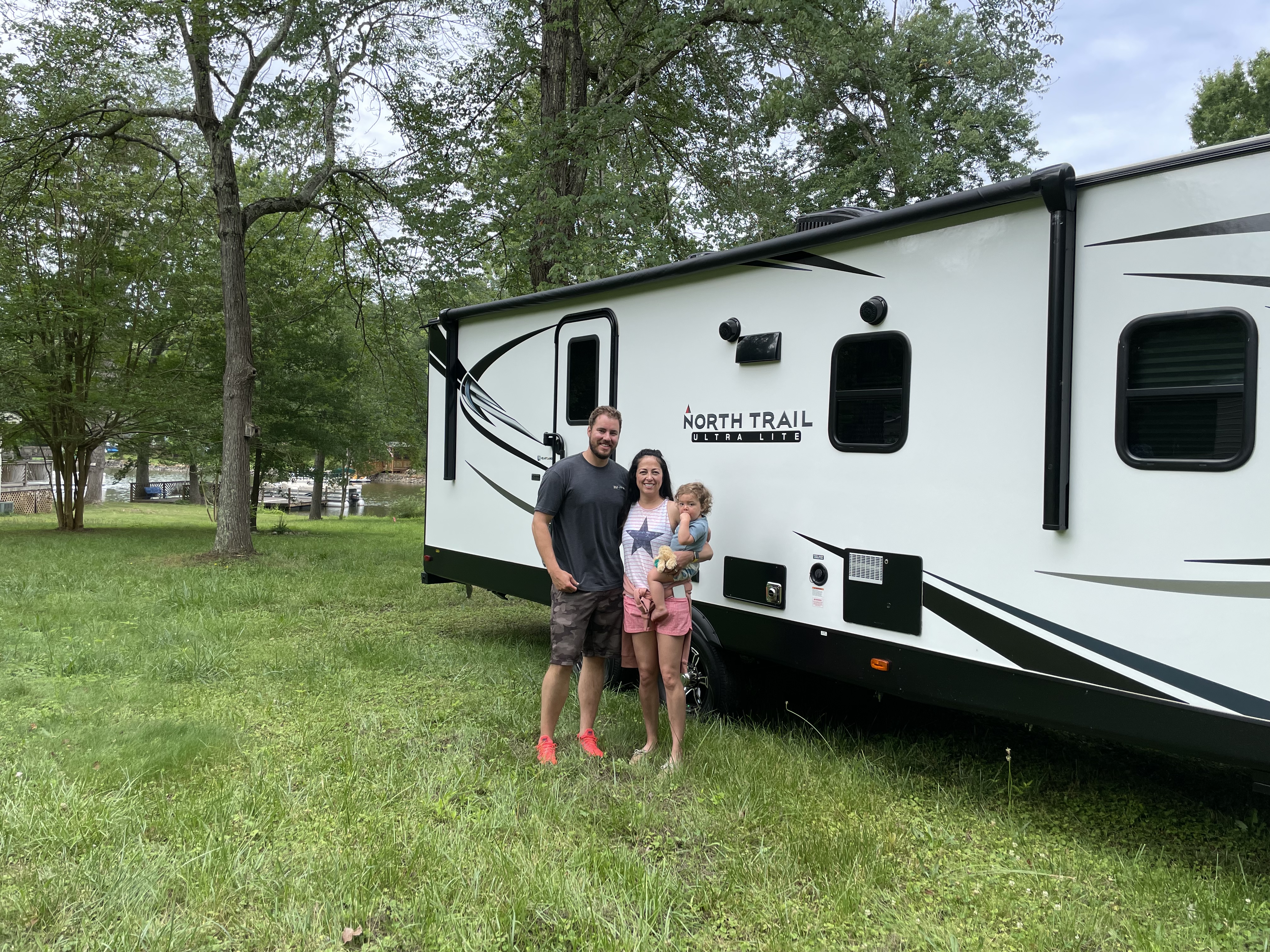Stephanie Deininger and her family posing for a photo in front of their RV on their first trip