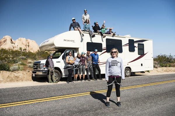 Participants from First Descents gather around a Jayco Class C RV in Joshua Tree National Park. 