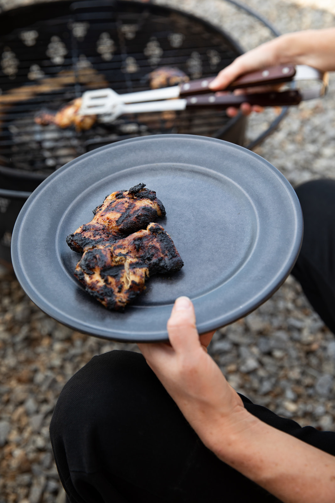 Crispy BBQ chicken being taken off the grill.