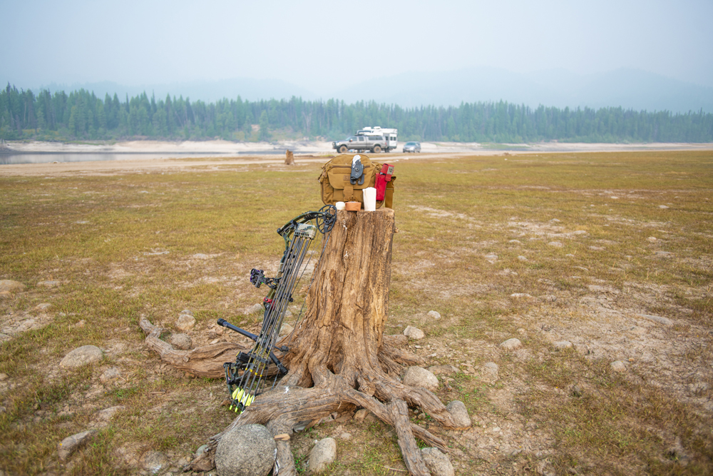 Hunting gear rests on a tree stump.