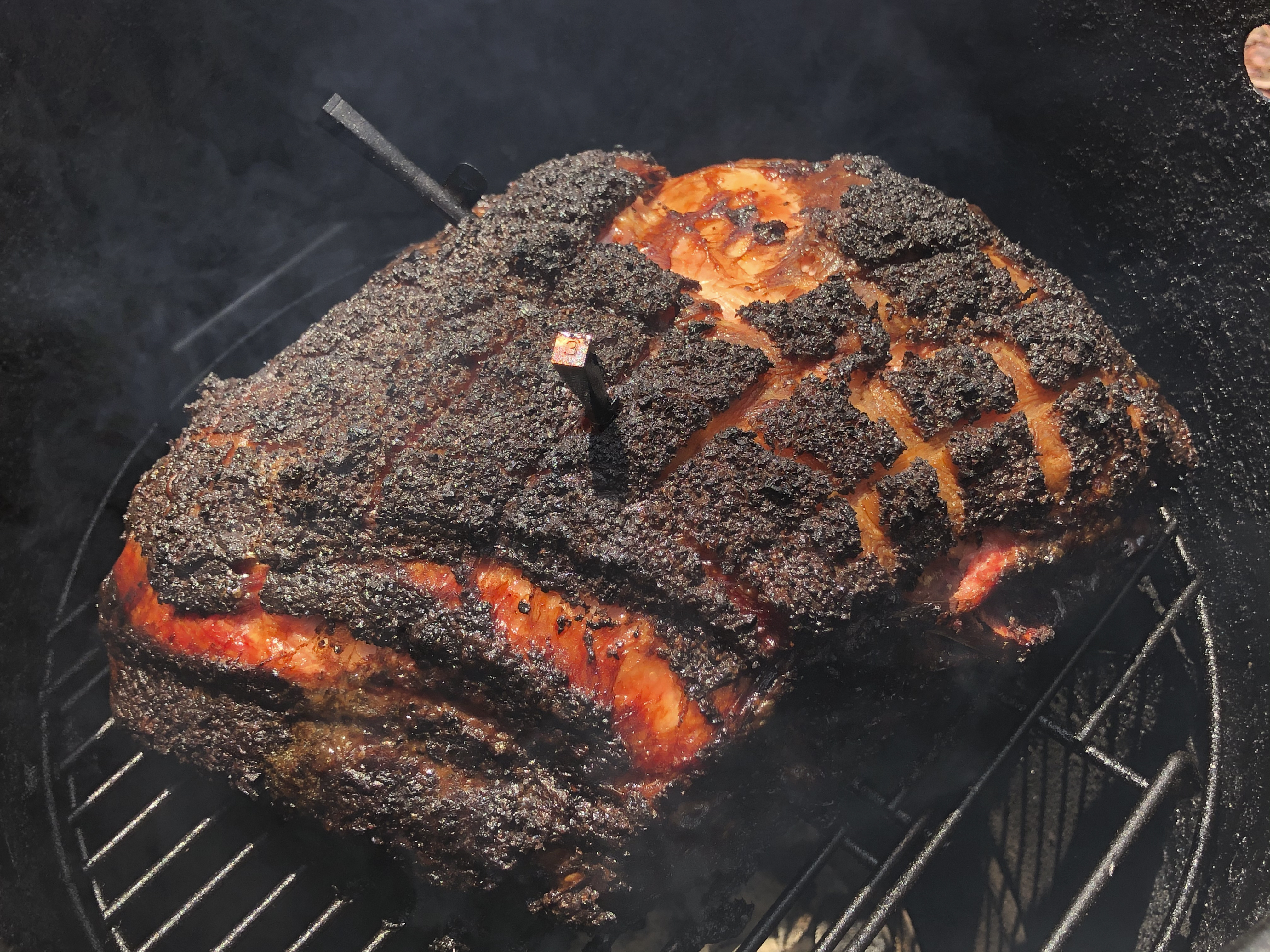 Pork smoking in a smoker.
